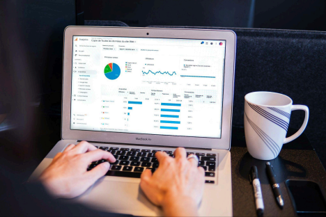 Person reviewing website analytics and campaign performance with a digital marketing dashboard on a laptop. 