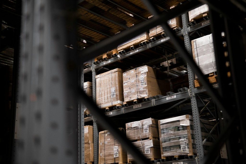 Shrink-wrapped boxes on racking in a warehousing facility before a move.